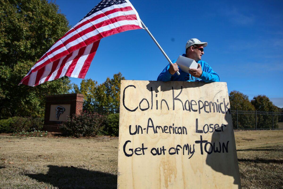 A man protests outside of the training facility where the Colin Kaepernick private NFL workout is being held in Flowery Branch, Georgia, on November 16, 2019. (Carmen Mandato/Getty Images)