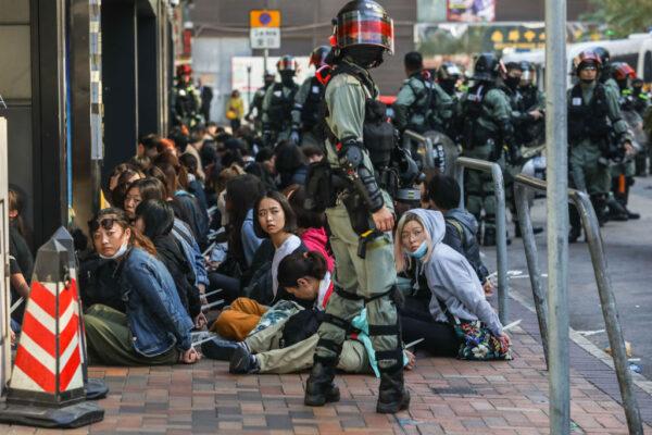 People are detained by police near the Hong Kong Polytechnic University in Hung Hom district of Hong Kong on Nov. 18, 2019. (Dale La Rey/AFP via Getty Images)