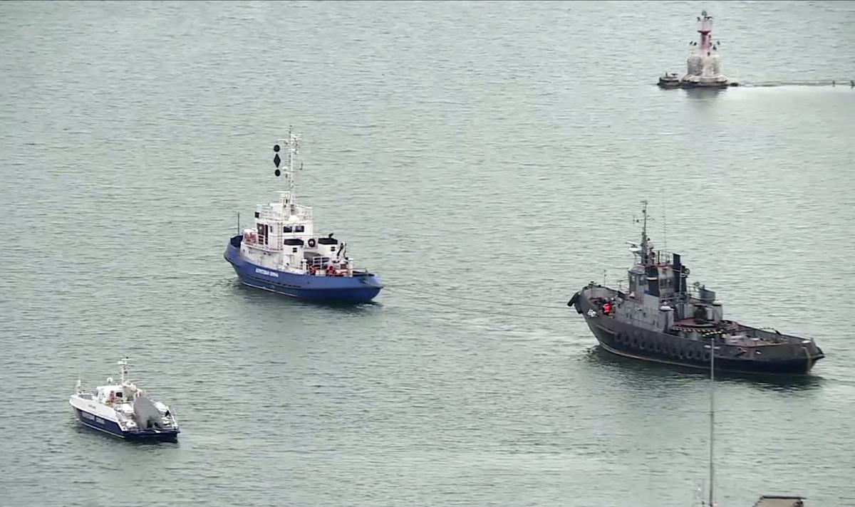 This video grab provided by the Krym 24 tv station via AP Television shows a seized Ukrainian ship, right, being towed by a Russian coast guard boat out of the port in Kerch, Crimea on Nov. 17, 2019. (Krym 24 tv station via AP Television)