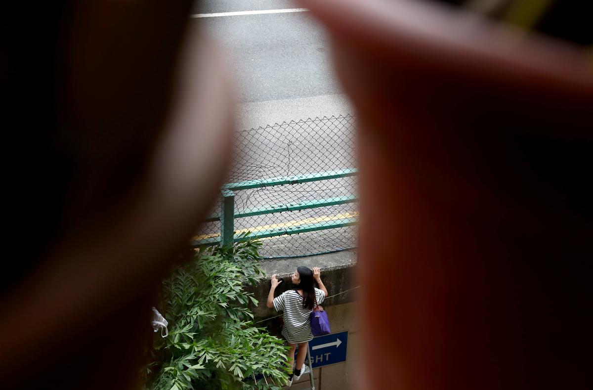 A protester tries to leave the campus of the Hong Kong Polytechnic University (PolyU), in Hong Kong on Nov. 19, 2019. (Athit Perawongmetha/Reuters)