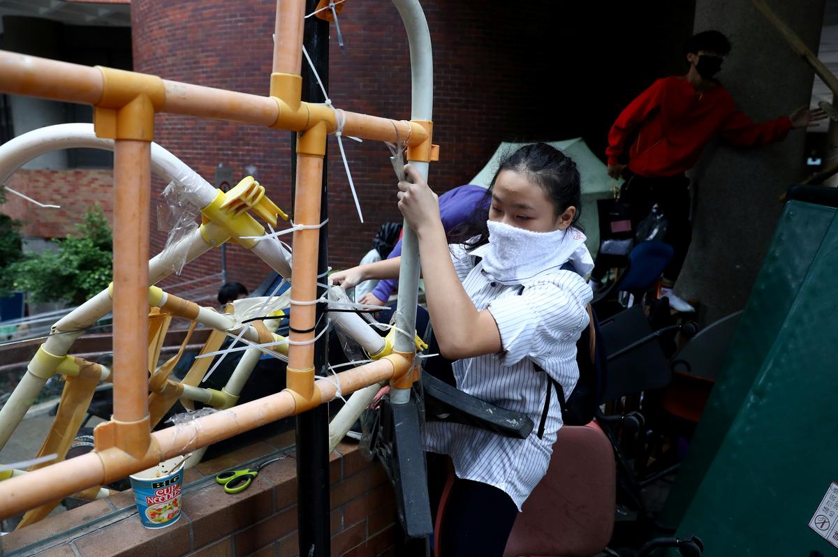 A protester tries to leave the Hong Kong Polytechnic University campus, in Hong Kong on Nov. 19, 2019. (Athit Perawongmetha/Reuters)