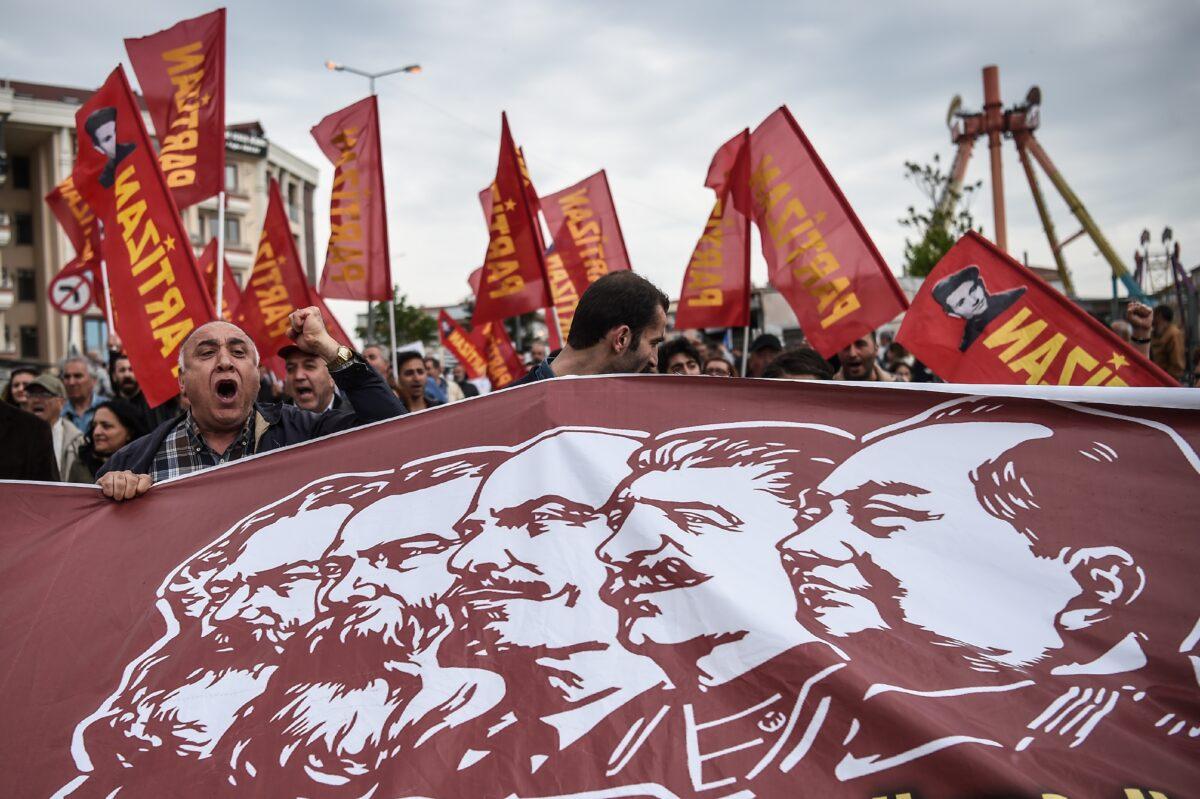 People hold a banner picturing Communist figures including (From L) Karl Marx, Friedrich Engels, Vladimir Ilitch Lenin, Joseph Stalin, and Mao Zedong, as they gather in Bakirkoy district as part of the May Day rally, in Istanbul, on May 1, 2017. (Ozan Kose/AFP/Getty Images)