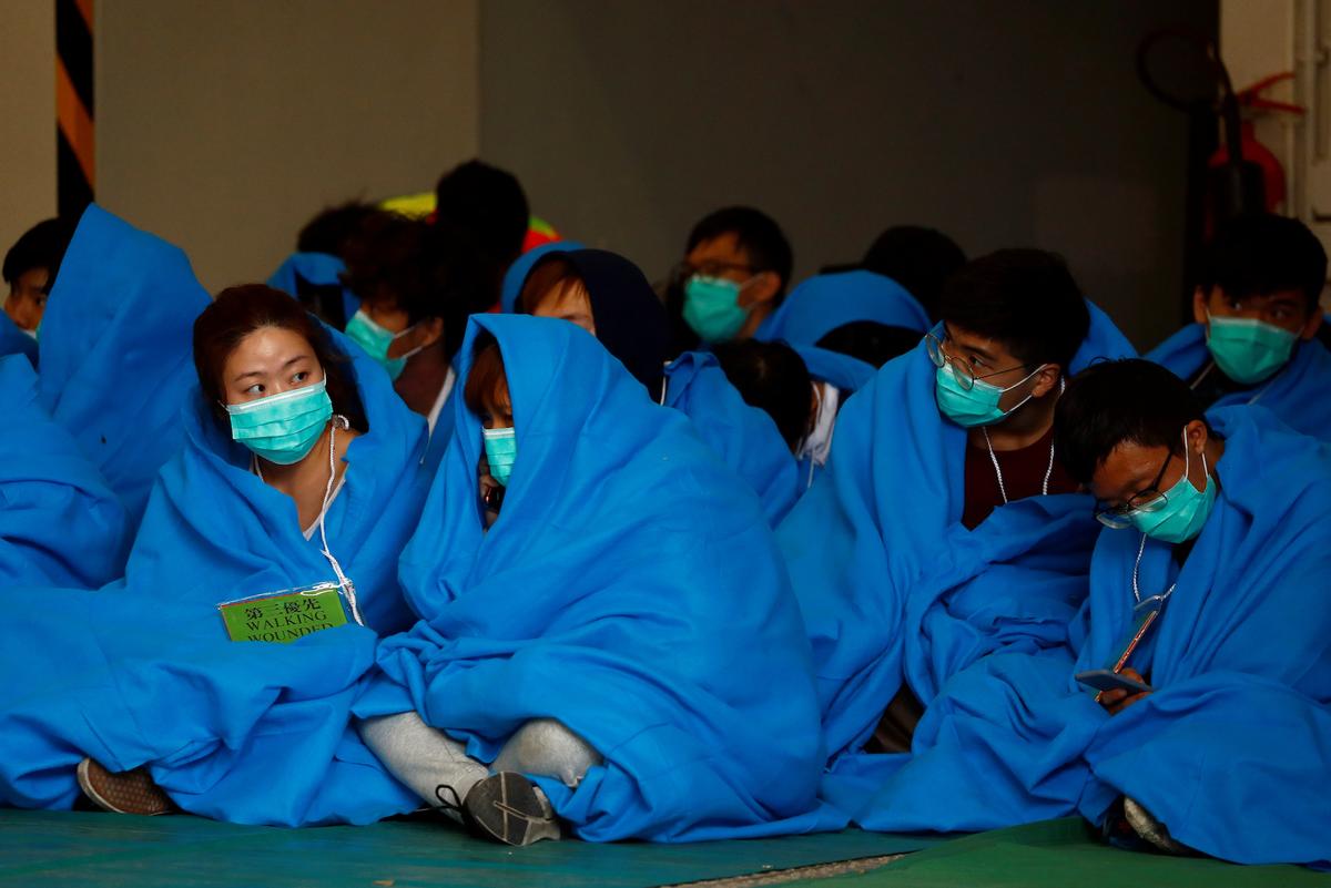 Protesters wait to receive medical attention after leaving the Hong Kong Polytechnic University campus, in Hong Kong on Nov. 19, 2019. (Thomas Peter/Reuters)