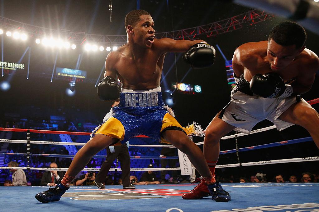 Haney (L) throws a left hook at Rafael Vazquez during their super featherweight fight in Las Vegas, Nevada, on April 9, 2016. (©Getty Images | <a href="https://www.gettyimages.com/detail/news-photo/devin-haney-throws-a-left-at-rafael-vazquez-during-their-news-photo/520254622">Christian Petersen</a>)