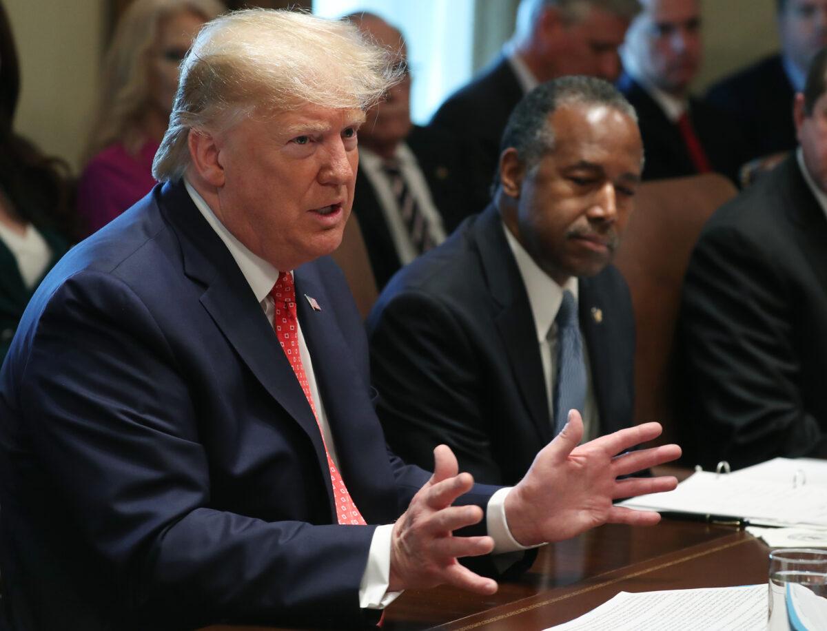 President Donald Trump speaks to the media during a cabinet meeting at the White House as Secretary of Housing Ben Carson, right, listens on Nov. 19, 2019. (Mark Wilson/Getty Images)