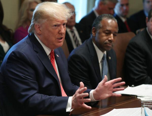 President Donald Trump speaks to the media during a cabinet meeting at the White House on Nov. 19, 2019, as Secretary of Housing Ben Carson, right, listens. (Mark Wilson/Getty Images)