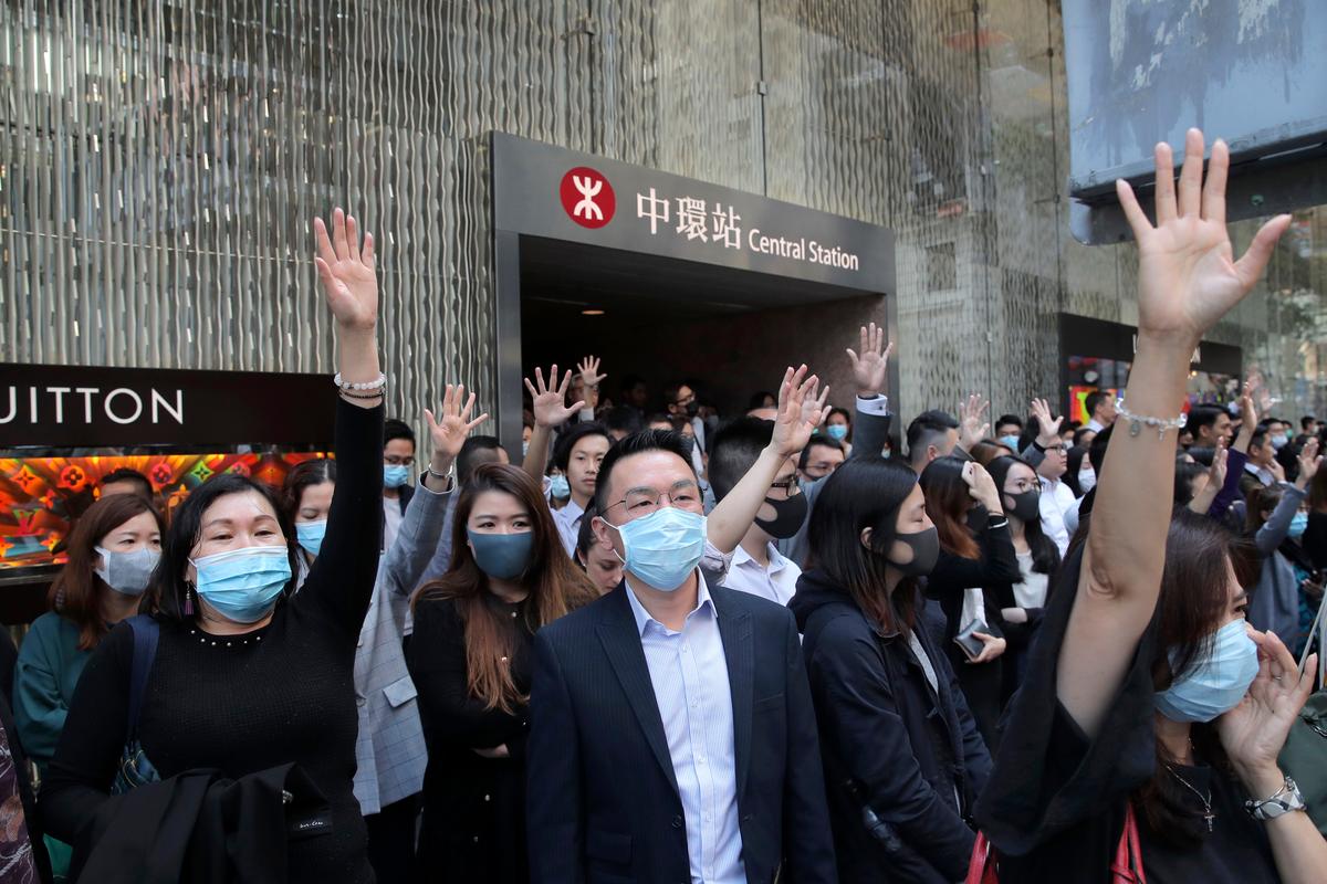 Protesters hold up their hands to symbolize pro-democracy demonstrators' five demands during a demonstration in the financial district in Hong Kong on Nov. 20, 2019. (Kin Cheung/AP)