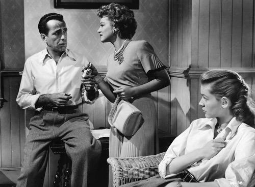 Claire Trevor (C), who won an Oscar for her role as Rocco’s moll, appears with Humphrey Bogart and Lauren Bacall. (MPTV Images / Warner Bros.)