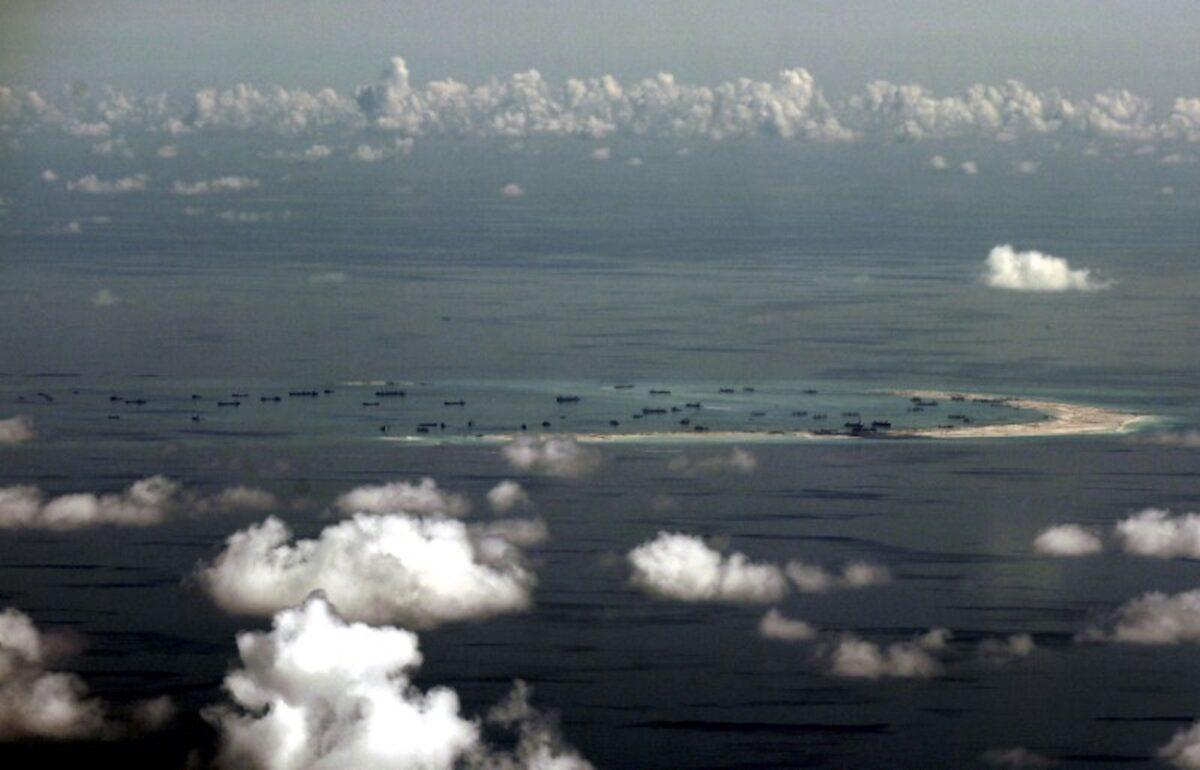 An aerial photo taken though a glass window of a Philippine military plane shows the alleged on-going land reclamation by China on Mischief Reef in the Spratly Islands in the South China Sea, west of Palawan, Philippines, on May 11, 2015. (Ritchie B. Tongo/Pool/Reuters)