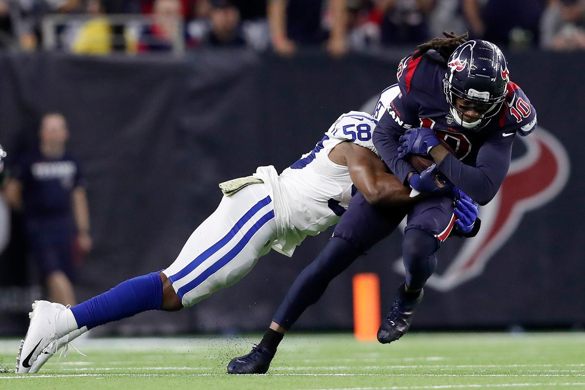 Hopkins is tackled by Bobby Okereke, #58 of the Indianapolis Colts, after a catch in the fourth quarter at NRG Stadium on Nov. 21, 2019. (©Getty Images | <a href="https://www.gettyimages.com/detail/news-photo/deandre-hopkins-of-the-houston-texans-is-tackled-by-bobby-news-photo/1183833064">Tim Warner</a>)