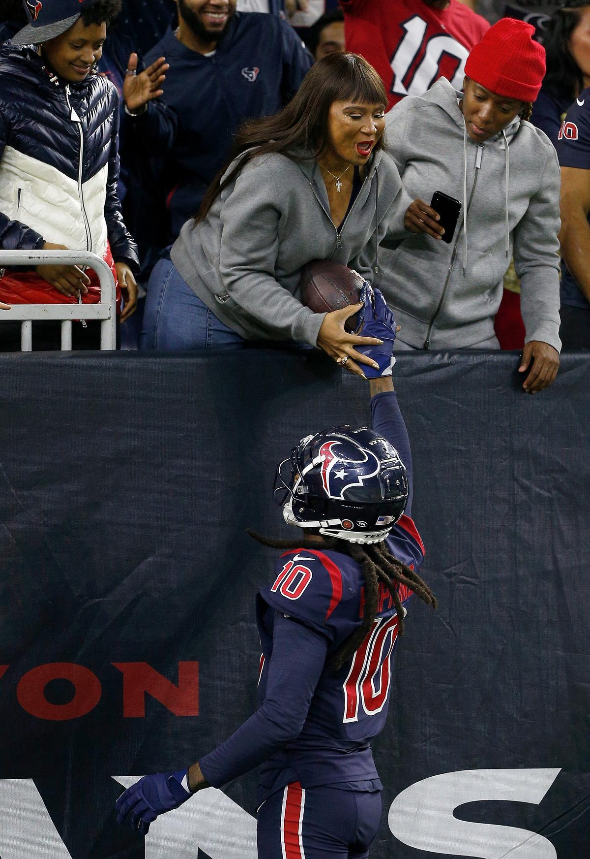 Hopkins, #10 of the Houston Texans, hands the ball to his mom after a touchdown in the second quarter against the Indianapolis Colts on Nov. 21, 2019. (©Getty Images | <a href="https://www.gettyimages.com/detail/news-photo/wide-receiver-deandre-hopkins-of-the-houston-texans-hand-news-photo/1189249696">Bob Levey</a>)