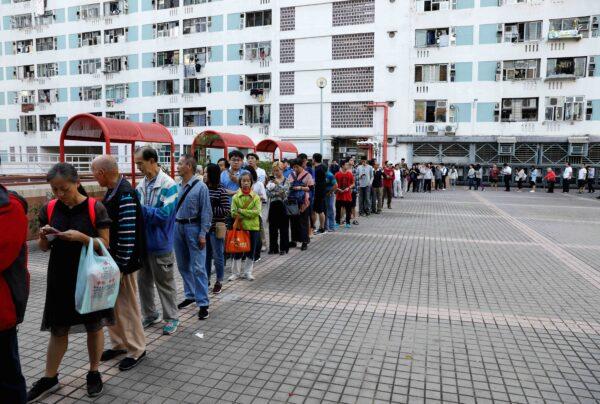 Voters queue outside a polling station during district council local elections in Hong Kong, China, on Nov. 24, 2019. (Adnan Abidi/Reuters)