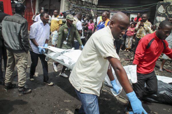 Rescuers remove bodies from the debris of an aircraft operated by private carrier Busy Bee which crashed in Goma, Congo on Nov. 24, 2019. (Justin Kabumba/AP Photo)