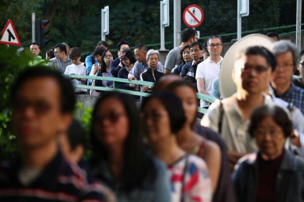 Voters line up at a polling station during district council local elections in Hong Kong, on Nov. 24, 2019. (Athit Perawongmetha/Reuters)