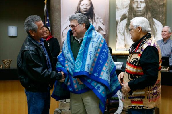 Attorney General William Barr, center, shakes hands with Vernon Finley, left, and Tony Incashola, right, on Friday, at the Flathead Reservation in Pablo, Mont. Nov. 22, 2019, (Patrick Semansky/AP)