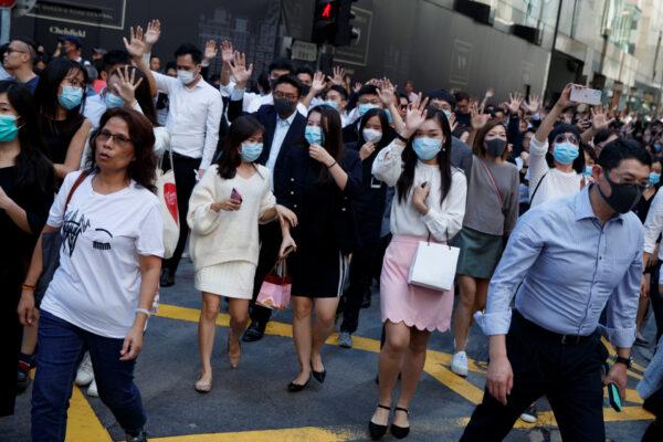 Office workers shout slogans as they attend a lunchtime anti-government protest in the Central district of Hong Kong, on Nov. 25, 2019. (Thomas Peter/Office workers shout slogans as they attend a lunchtime anti-government protest in the Central district of Hong Kong, China, November 25, 2019. (Thomas Peter/Reuters)