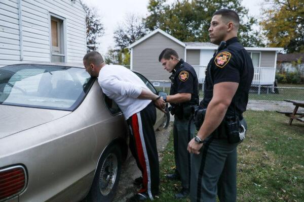 Montgomery County Sheriff's deputies arrest a man for trespassing and suspected drug possession in the Harrison Township of Dayton, Ohio, on Oct. 29, 2019. (Charlotte Cuthbertson/The Epoch Times)