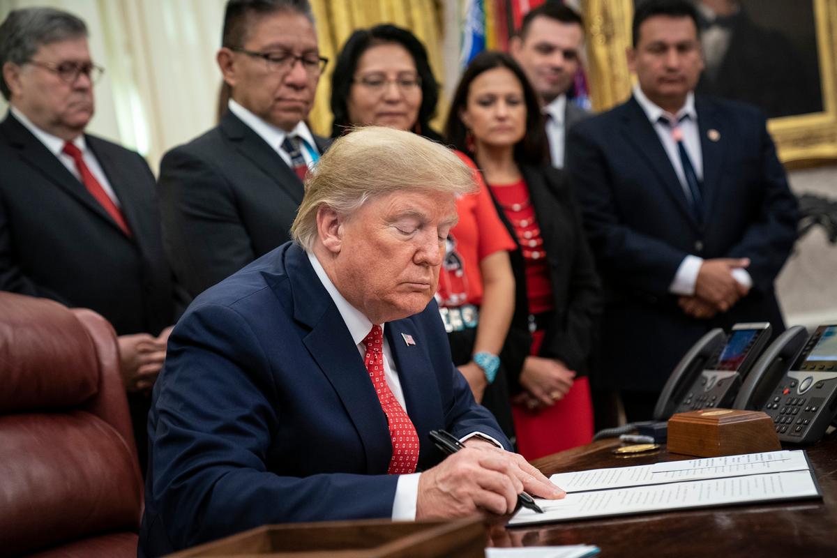 President Donald Trump signs an executive order establishing the Task Force on Missing and Murdered American Indians and Alaska Natives, in the Oval Office of the White House in Washington on Nov. 26, 2019. (Drew Angerer/Getty Images)