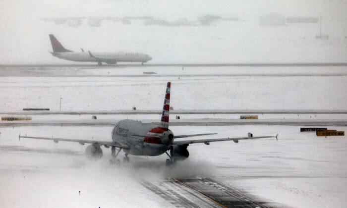 An American Airlines jet taxis down a snow-covered runway after a pre-Thanksgiving holiday snowstorm caused more than 460 flight cancellations at Denver International Airport, on Nov. 26, 2019. (Bob Strong/Reuters)