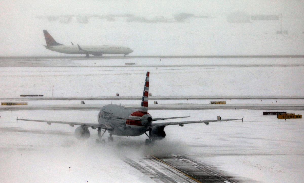 An American Airlines jet taxis down a snow-covered runway after a pre-Thanksgiving holiday snowstorm caused more than 460 flight cancellations at Denver International Airport, Colorado on Nov. 26, 2019. (Bob Strong/Reuters)