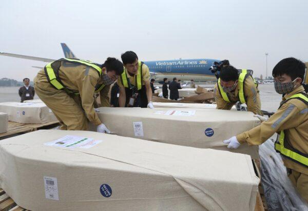 Coffins arrive on the tarmac of the Noi Bai airport on Nov. 27, 2019, in Hanoi, Vietnam. (Vietnam News Agency via AP)