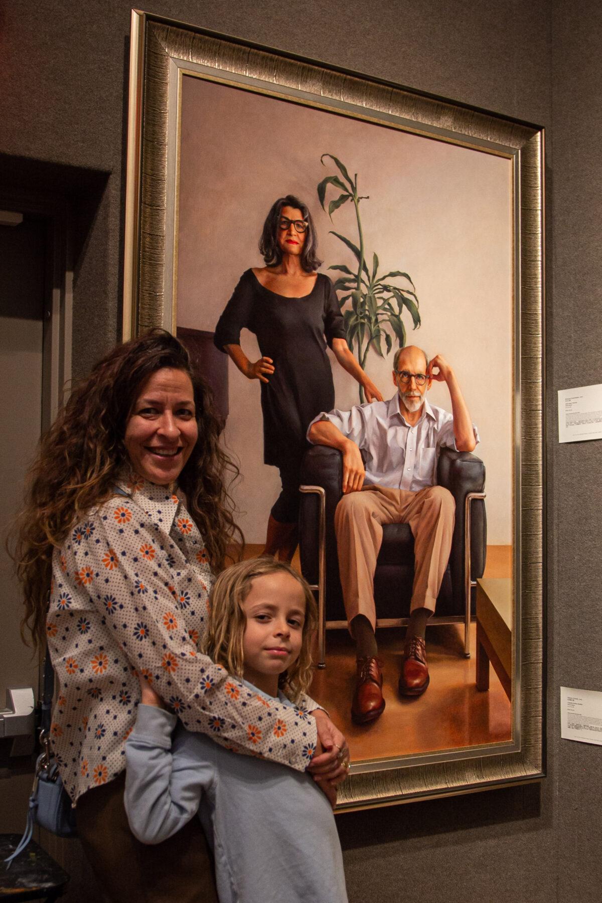 Family members of Ken Goshen with his work "The Pause" at the 5th NTD International Figure Painting Competition exhibition at the Salmagundi Club in New York on Nov. 26, 2019. (Chung I Ho/The Epoch Times)