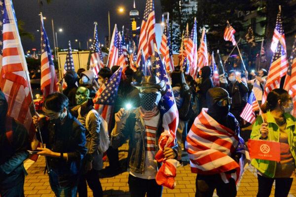 Protestors hold U.S. flags as they attend a gathering at the Edinburgh place in Hong Kong on Nov. 28, 2019. (Sung Pi Lung/The Epoch Times)