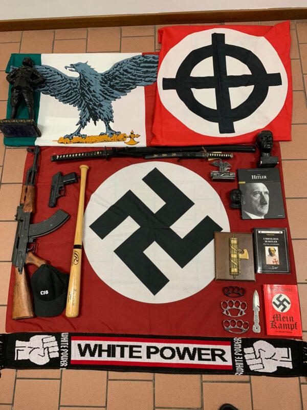 Italian police handout shows weapons and a Nazi flag with a swastika that they say were seized in searches of properties of an extreme political group who planned to create a new Nazi party, in an unidentified location in Italy in a picture released on Nov. 28, 2019. (Polizia di Stato/Handout via REUTERS)