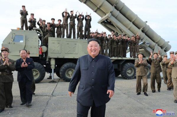 North Korean leader Kim Jong Un, center, smiles after the test-firing of an unspecified missile at an undisclosed location in North Korea on Aug. 24, 2019. (Korean Central News Agency/Korea News Service via AP)