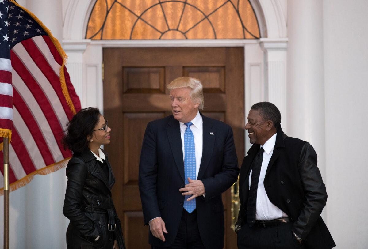 President-elect Donald Trump, center, meets with Lauren Wooden, left, and her husband Robert Johnson, the founder of Black Entertainment Television, at Trump International Golf Club in Bedminster Township, New Jersey on Nov. 20, 2016. (Drew Angerer/Getty Images)
