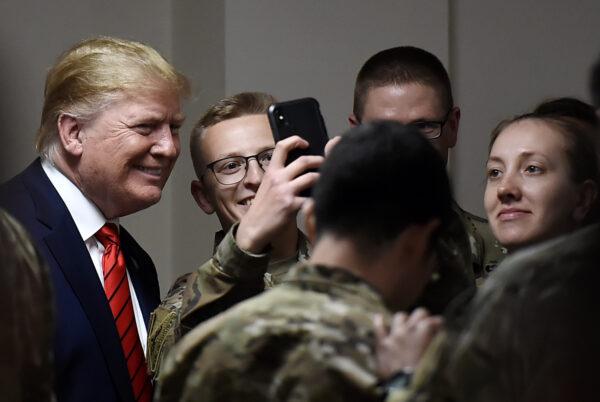 President Donald Trump poses for selfies during a Thanksgiving dinner with U.S. troops at Bagram Air Field in Afghanistan on Nov. 28, 2019. (Olivier Douliery/AFP via Getty Images)