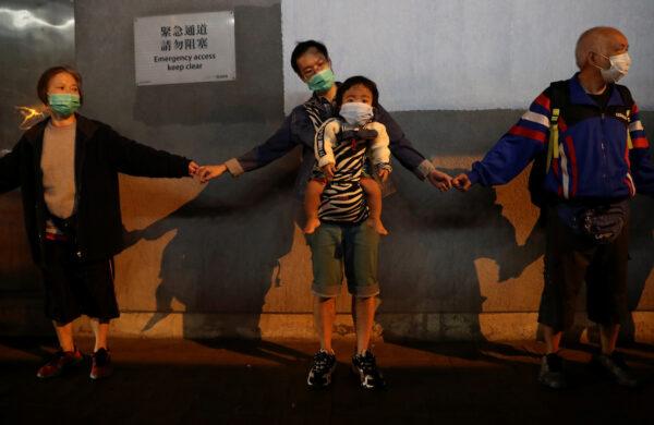 Protesters hold hands to form a human chain at Kowloon Bay in Hong Kong, China, on Nov. 30, 2019. (Leah Millis/Reuters