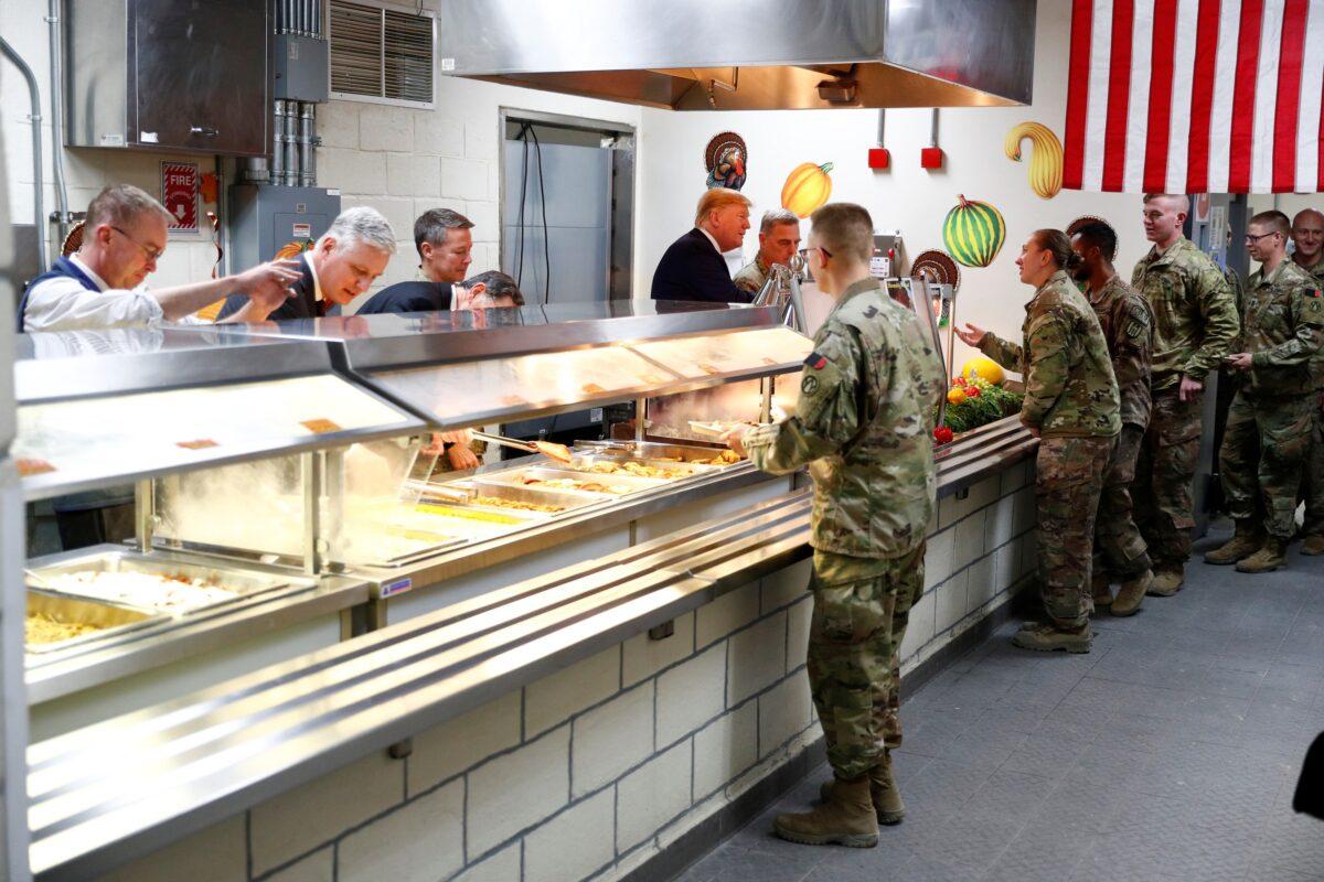 President Donald Trump serves U.S. troops food at a Thanksgiving dinner event during a surprise visit at Bagram Air Base in Afghanistan on Nov. 28, 2019. (Tom Brenner/Reuters)