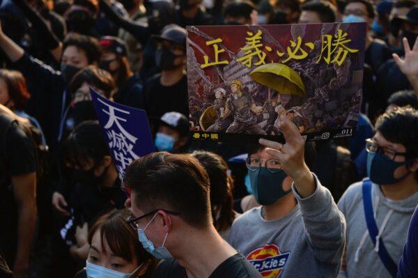 A protester holds a sign that reads "justice will prevail" during a mass rally on Dec. 1. (Gordon Yu/The Epoch Times)