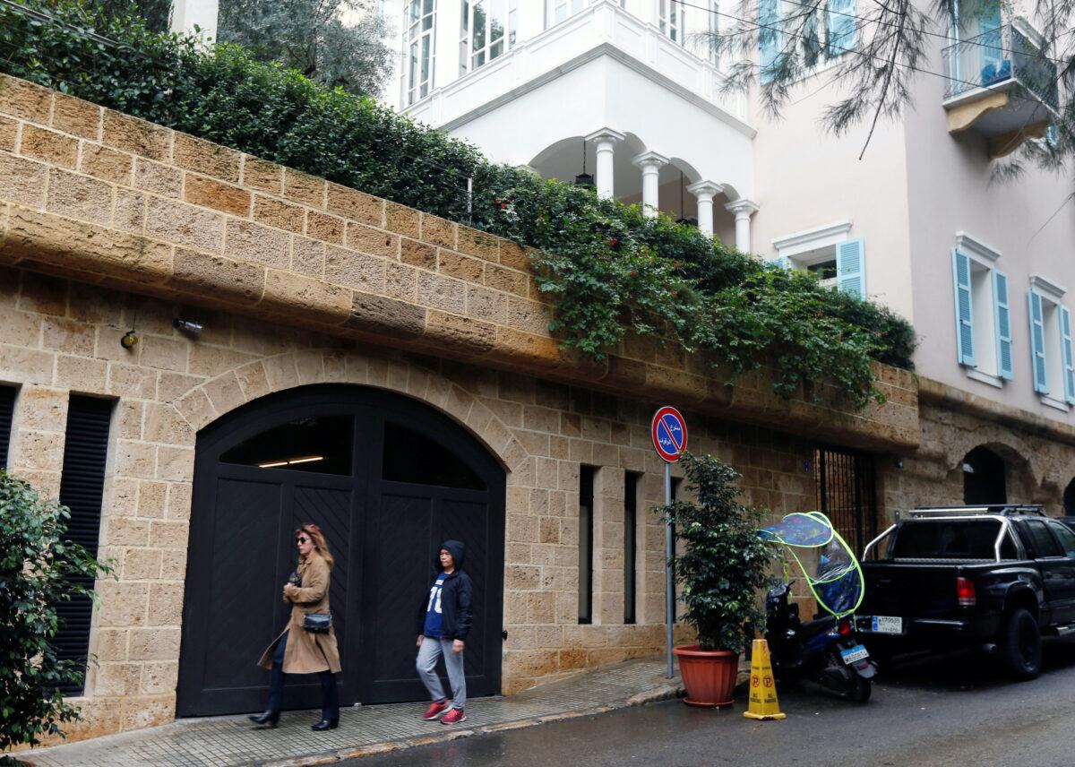 People walk past a house that is believed to belong to Carlos Ghosn in Beirut, Lebanon, on Dec. 31, 2019. (Mohamed Azakir/Reuters)