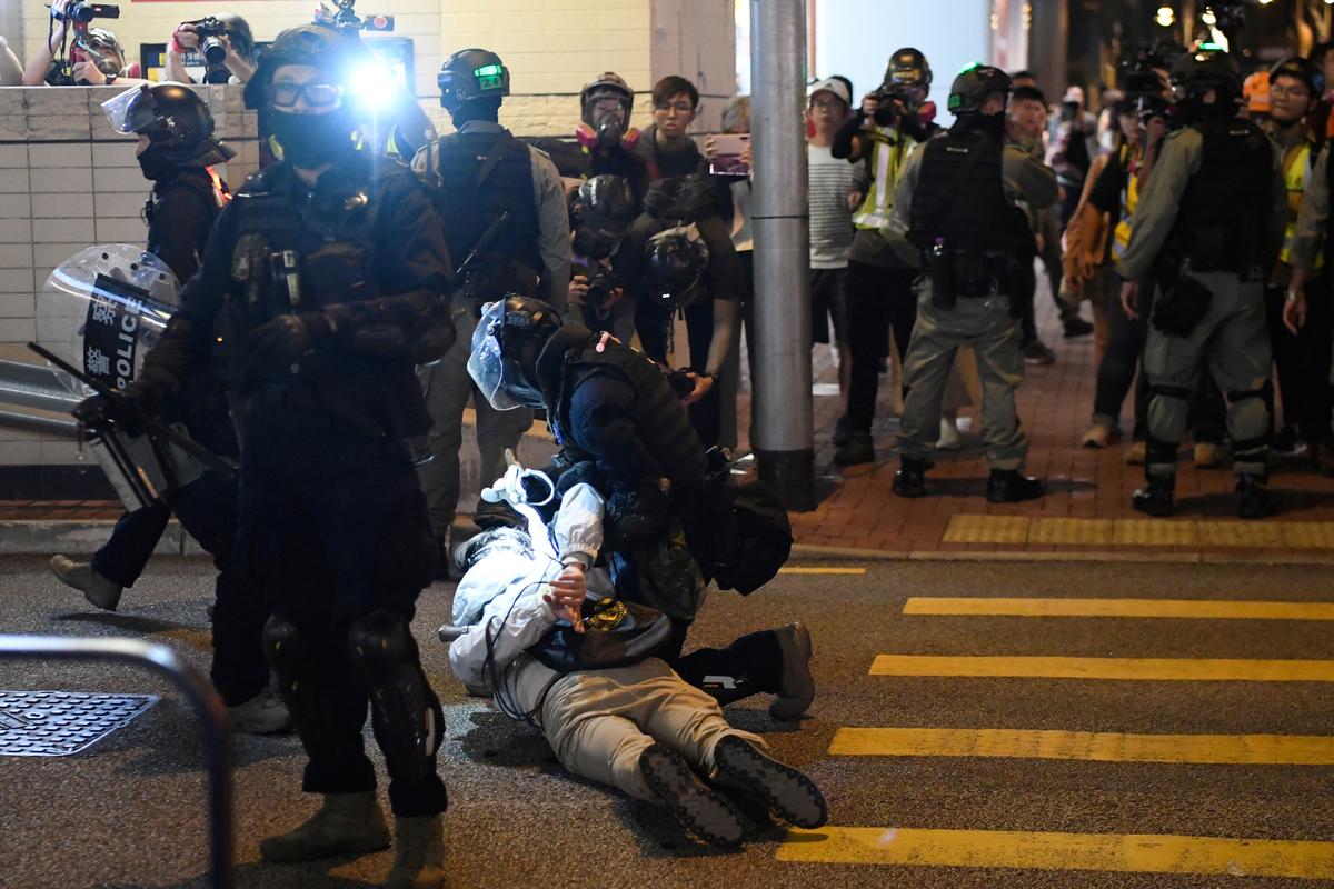 Riot police arrest a man in the neighborhood of Hung Hom after a protest in Kowloon in Hong Kong on Dec. 1, 2019. (Laurel Chor/Reuters)
