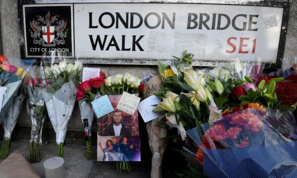 Messages of condolence and floral tributes, including a photograph of victim Jack Merritt, are seen near the scene of a stabbing on London Bridge, in London on Dec. 1, 2019. (Toby Melville/Reuters)