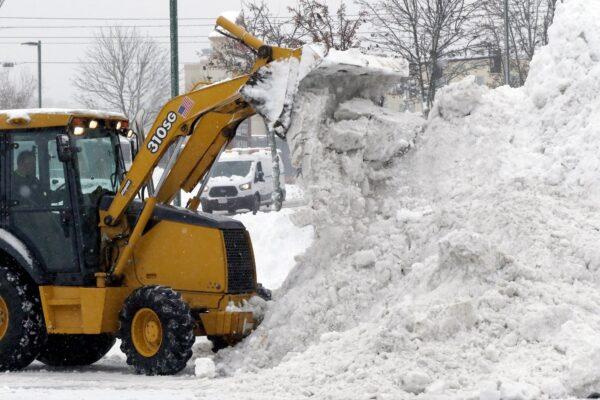 A front end loader piles snow while clearing a parking lot after an overnight snowfall on Dec. 2, 2019, in Marlborough, Mass. (Bill Sikes/AP Photo)