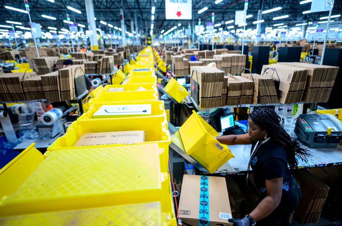 A woman works at a packing station at the 855,000-square-foot Amazon fulfillment center in Staten Island, one of the five boroughs of New York City, on Feb. 5, 2019. (JOHANNES EISELE/AFP via Getty Images)