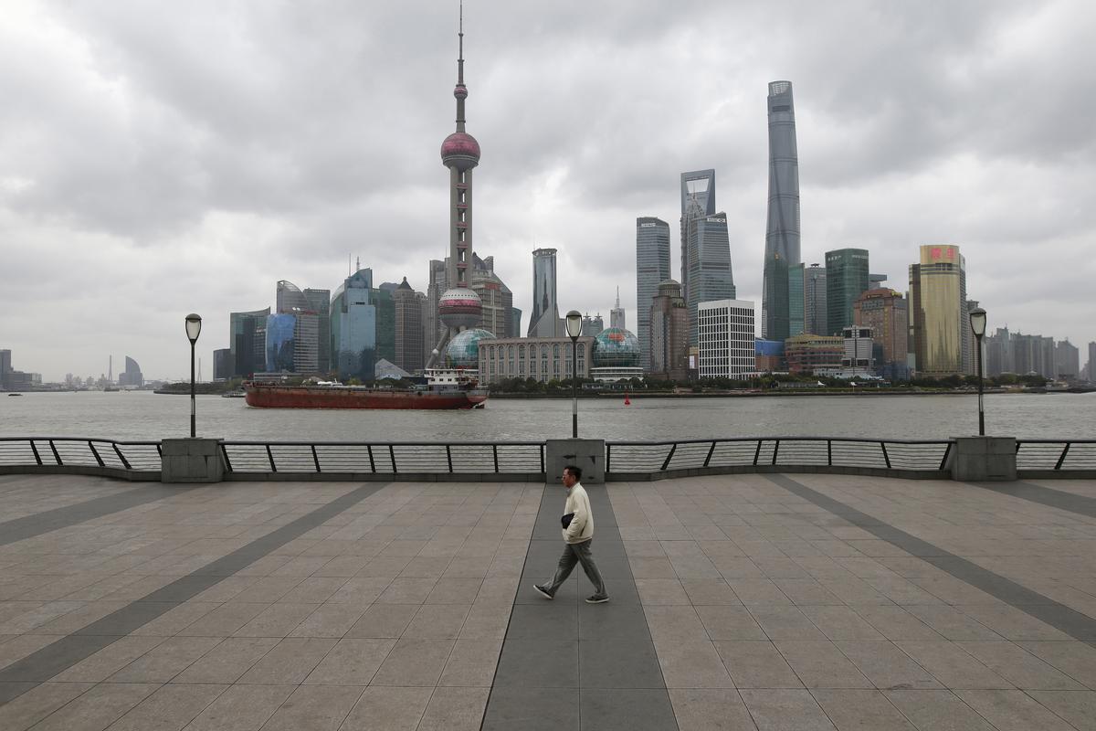 A man walks on the bund in front of the financial district of Pudong in Shanghai, China on March 9, 2016. (Aly Song/Reuters)
