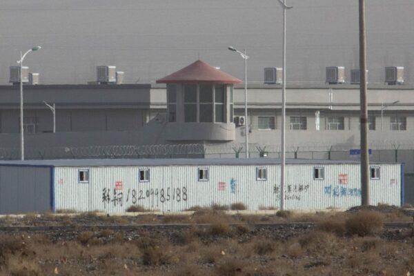 A guard tower and barbed wire fences are seen around a facility in the Kunshan Industrial Park in Artux in western China's Xinjiang region, on Dec. 3, 2018. (AP Photo/Ng Han Guan)