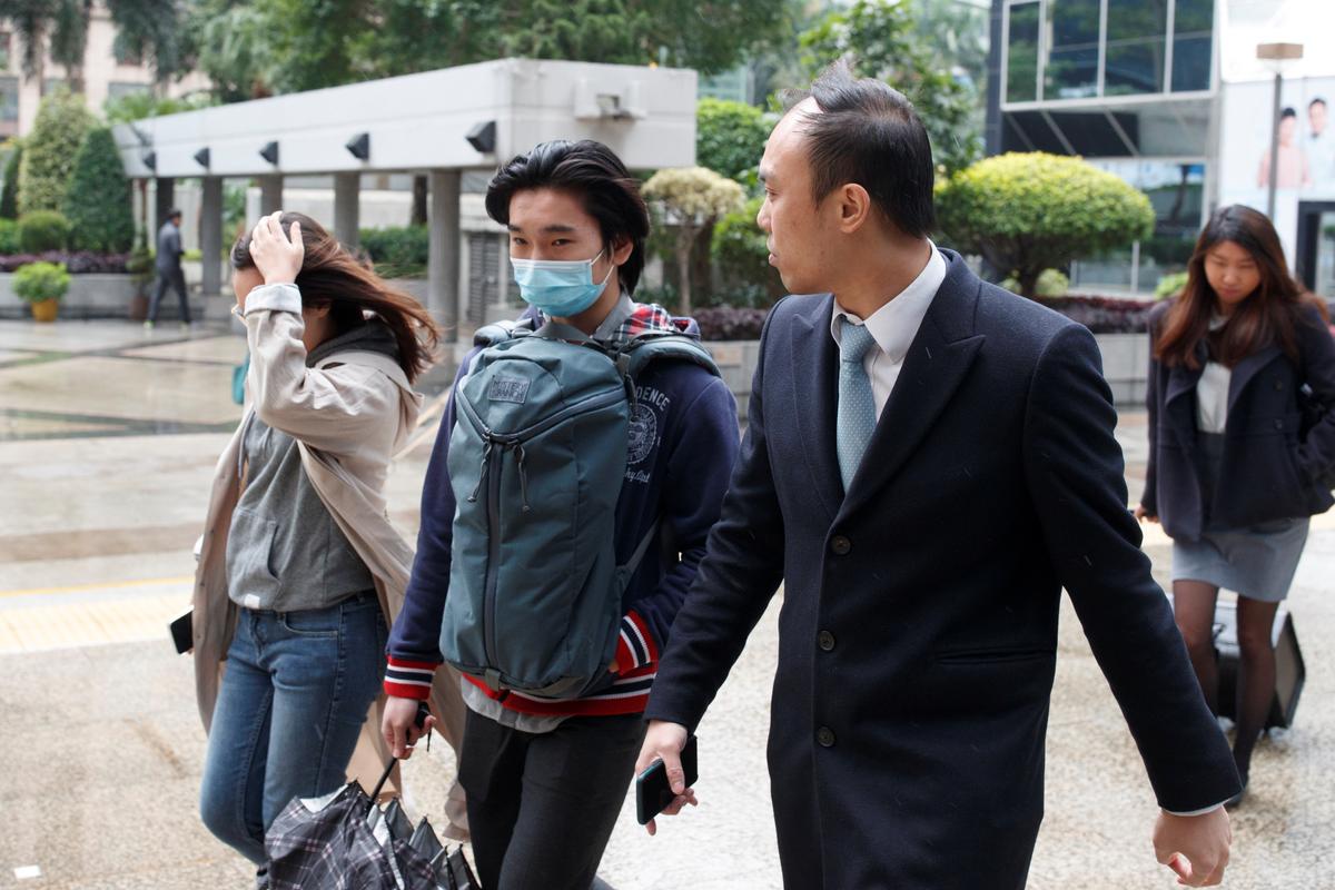 Tsang Chi-Kin (C), who was shot by a police officer during a protest, arrives for a court hearing in Hong Kong on Dec. 5, 2019. (Thomas Peter/Reuters)