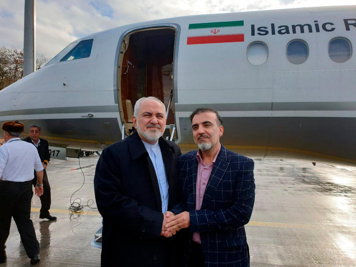 Iran's Foreign Minister Mohammad Javad Zarif (L)  shakes hand with Iranian scientist Massoud Soleimani prior to leaving Zurich for Tehran on Dec. 7, 2019. (Javad Zarif Twitter account via AP)