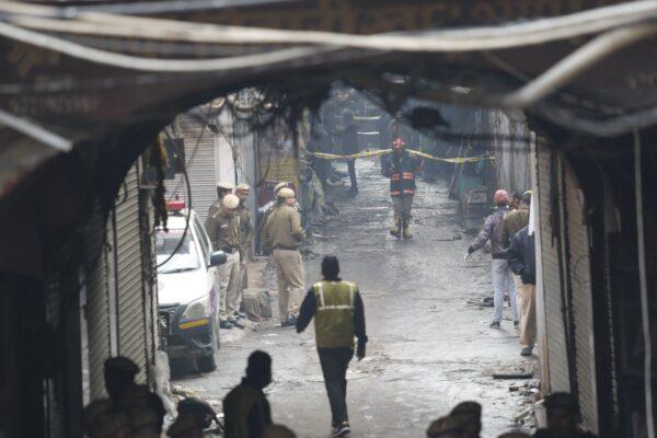 Police officers cordon off the site of a fire in a narrow lane in New Delhi, India, on Dec. 8, 2019. (Manish Swarup/AP Photo)