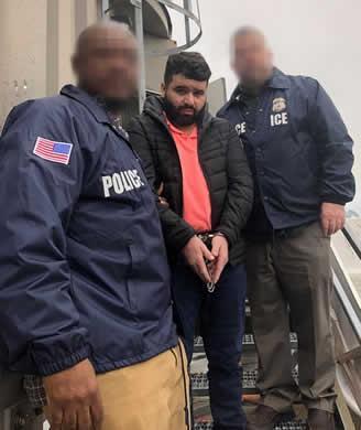 Bruno Padua-Silva escorted by ICE officers. (ICE)