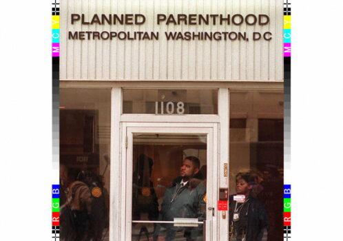 Police officers look out from a Planned Parenthood clinic in downtown Washington on Jan. 22, 1997. Joyce Naltchayan/AFP via Getty Images