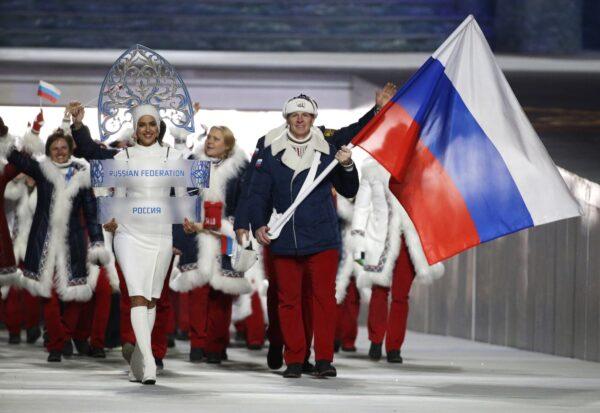 Alexander Zubkov of Russia carries the national flag as he leads the team during the opening ceremony of the 2014 Winter Olympics in Sochi, Russia, on Feb. 7, 2014. (Mark Humphrey/AP Photo)