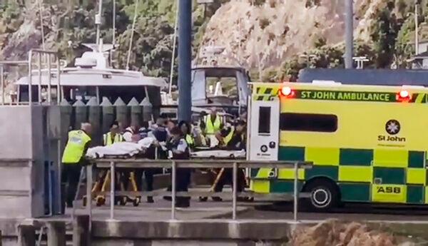 In this image made from video, injured from White Island volcanic eruption are ferried into waiting ambulances in Whakatane, New Zealand, Monday, Dec. 9, 2019. A volcano erupted Monday on a small New Zealand island frequented by tourists, and a number of people were missing and injured after the eruption. (Katee Shanls/NZME via AP)