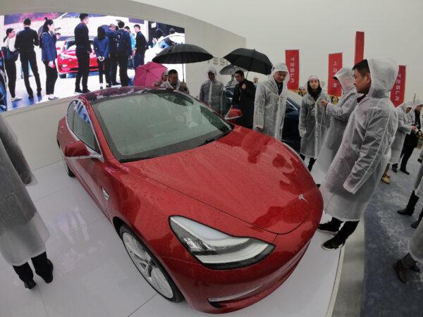 Guests look at a Tesla Model 3 during a ground-breaking ceremony for a Tesla factory in Shanghai, China on Jan. 7, 2019. (STR/AFP via Getty Images)