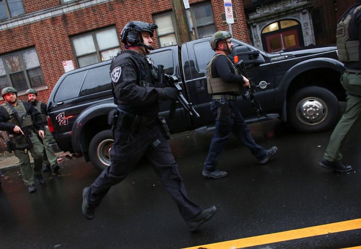 Police officers arrive at the scene of an active shooting in Jersey City. One officer was shot when two gunmen with a long rifle opened fire. Two suspects were barricaded in a convenience store, according to officials on Dec. 10, 2019. (Photo by Kena Betancur/AFP via Getty Images)